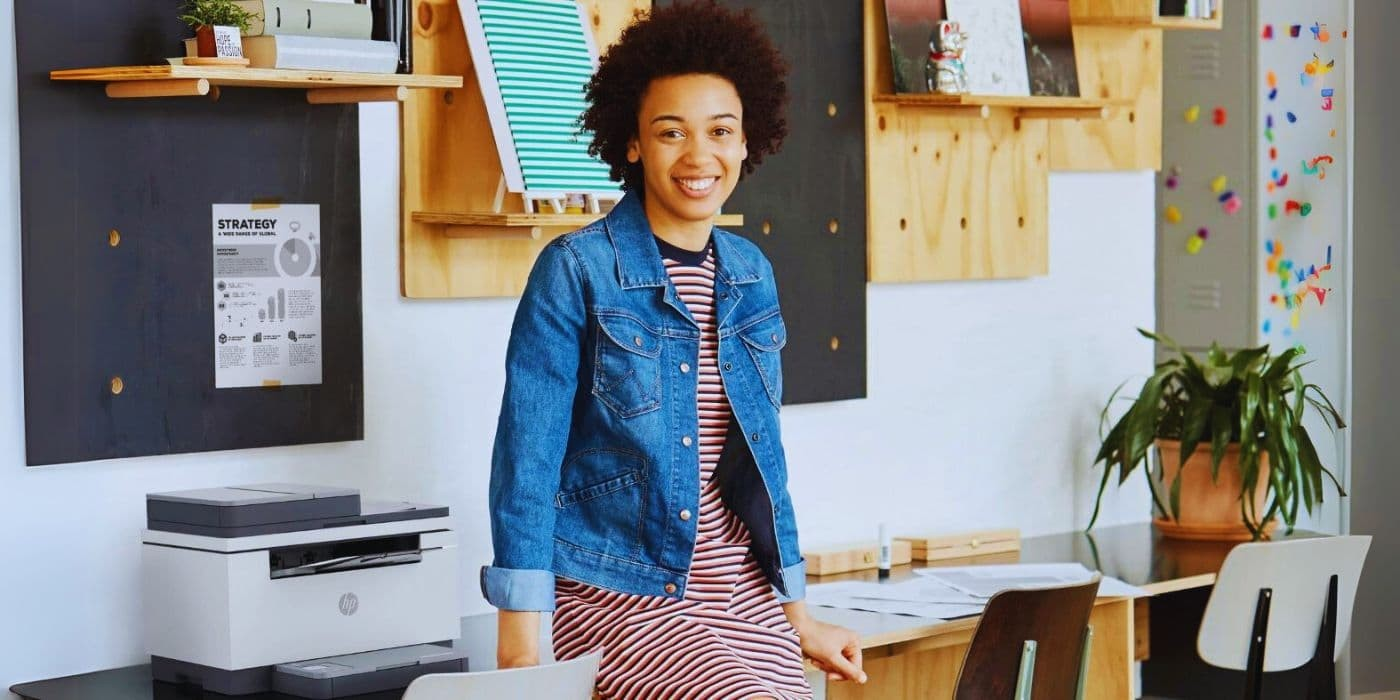 Woman next to an HP Colour Laser Printer for Home Office Professionals